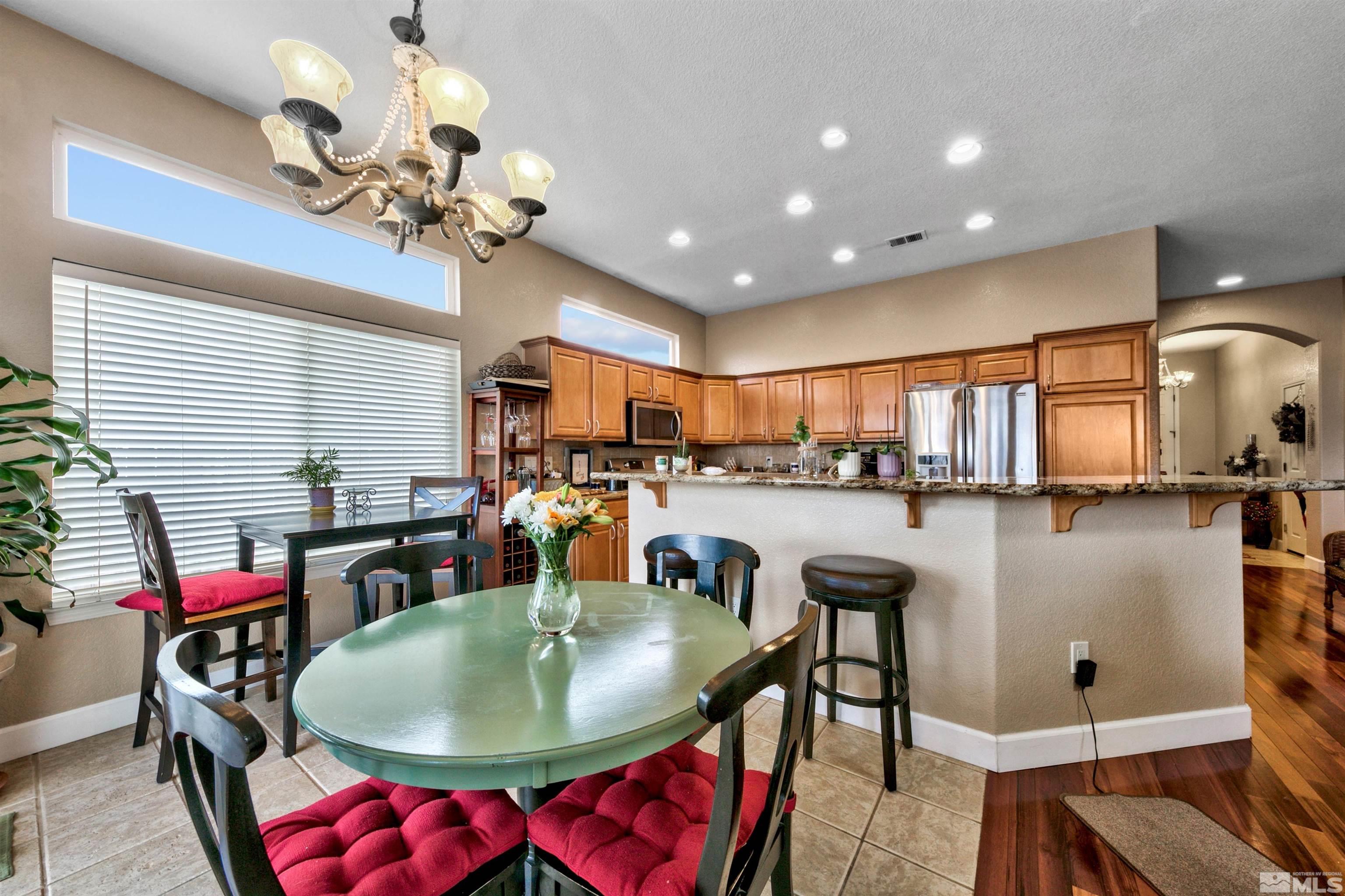 2831 Longridge Drive Carson City, NV 89706 - Photo 8 of 27 a dining room with furniture a chandelier and kitchen view