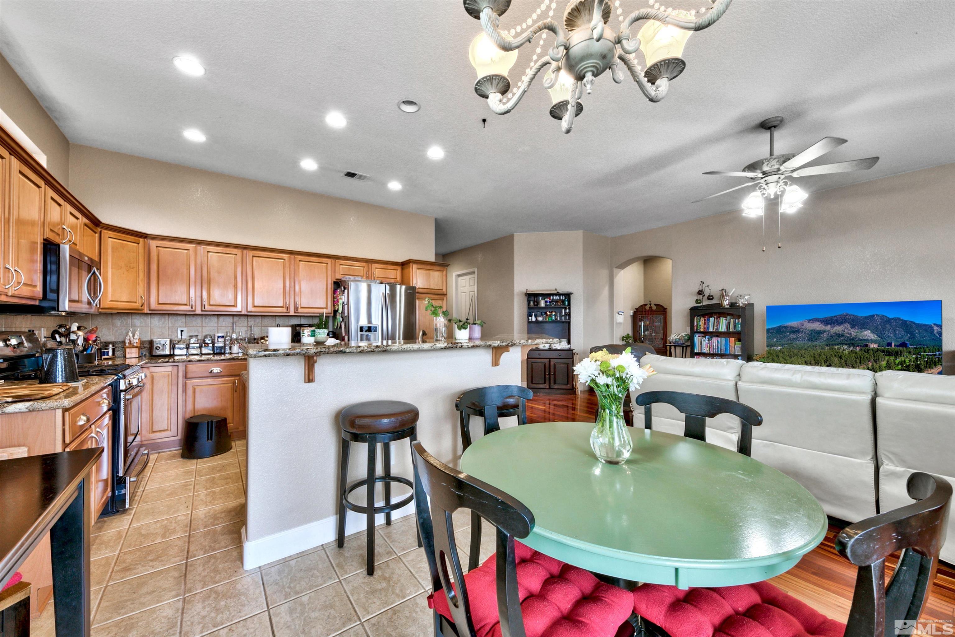2831 Longridge Drive Carson City, NV 89706 - Photo 9 of 27 a living room with stainless steel appliances furniture a dining table and kitchen view