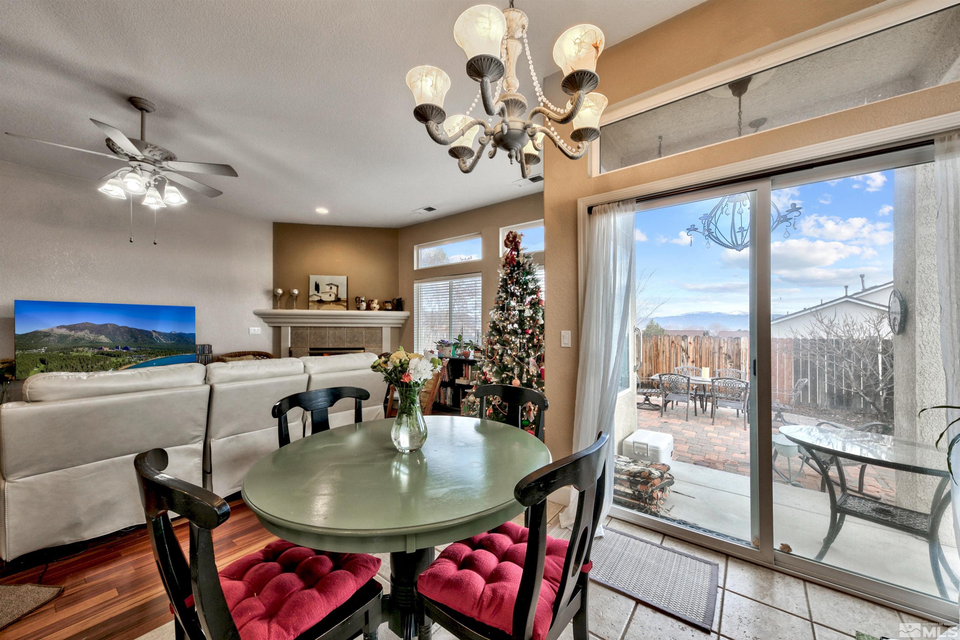 2831 Longridge Drive Carson City, NV 89706 - Photo 10 of 27 a view of a dining room with furniture a chandelier and large windows