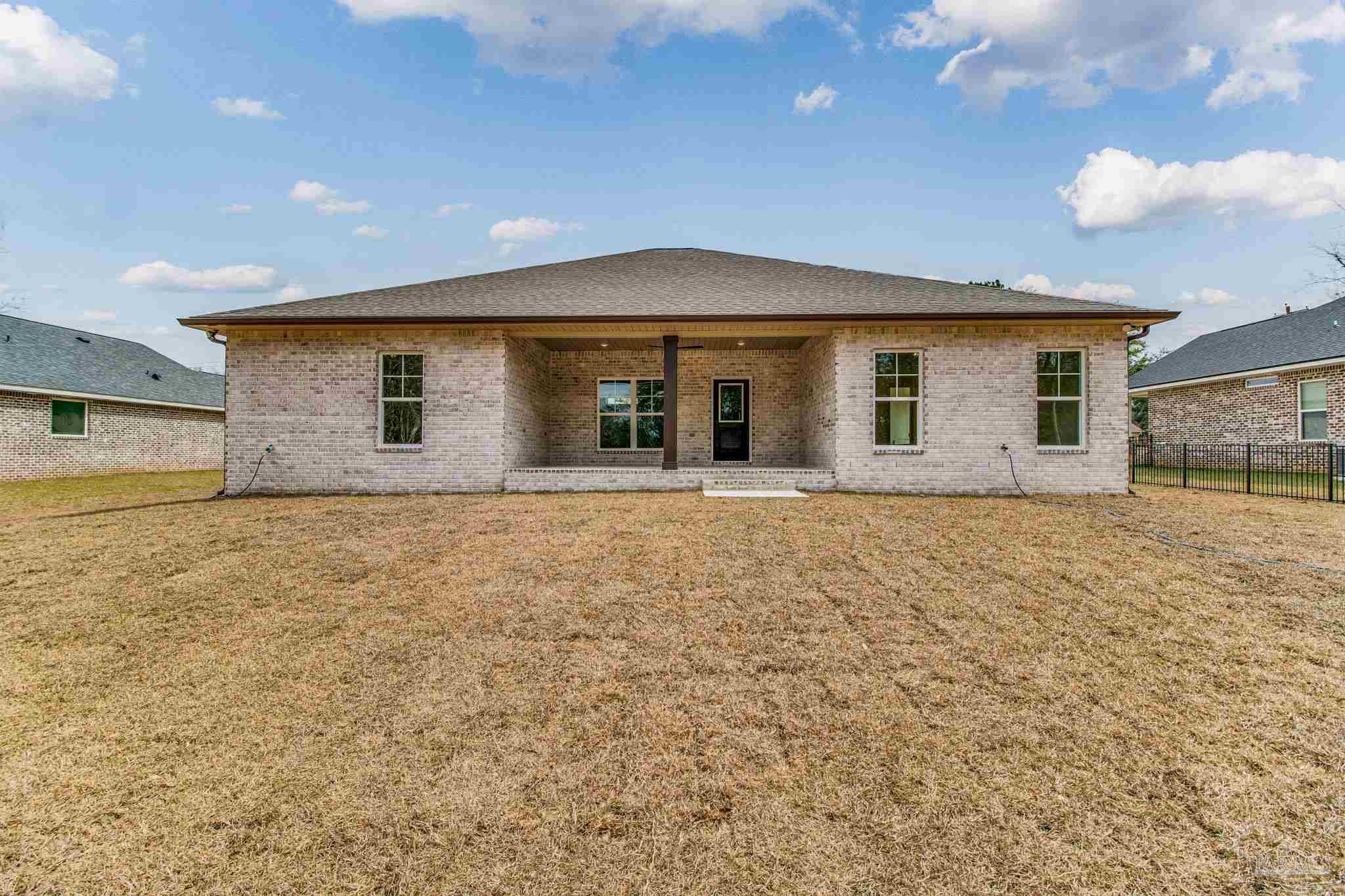 4310 Watkins Street Pace, FL 32571 - Photo 16 of 58 a front view of a house with large garden