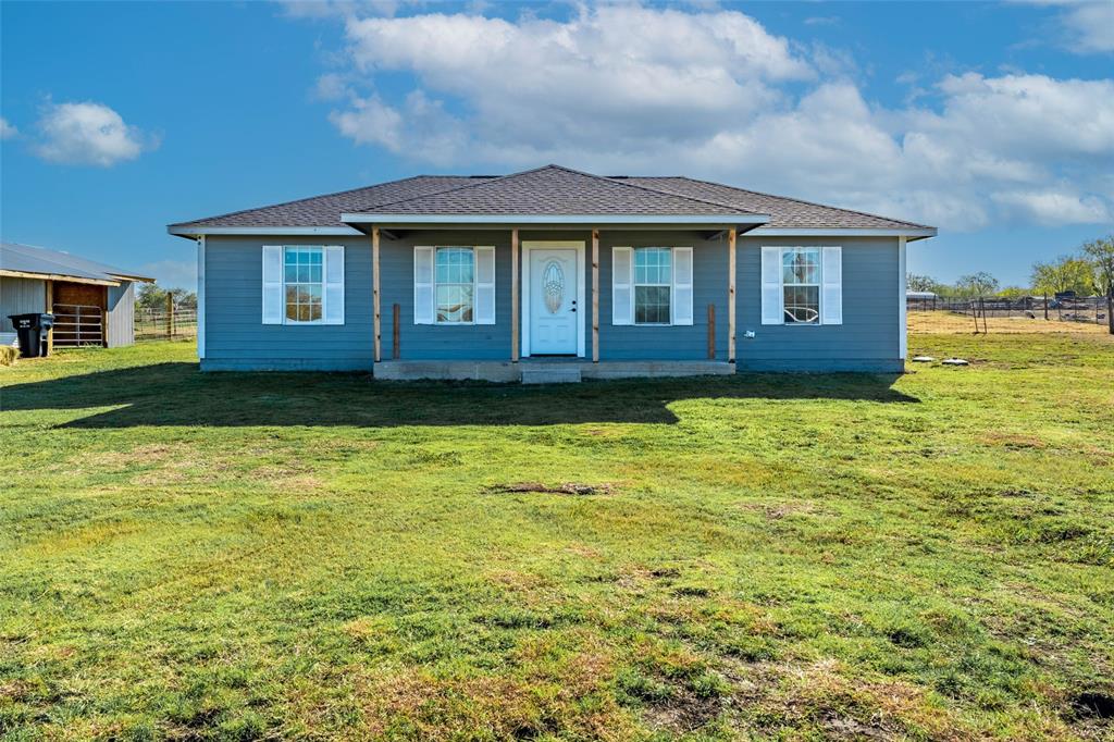 a front view of a house with a yard
