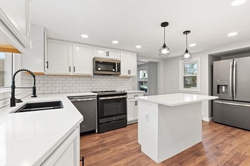 18 Wainwright Avenue Haverhill, MA 01835 - Photo 3 of 10 a kitchen with a sink stove and refrigerator