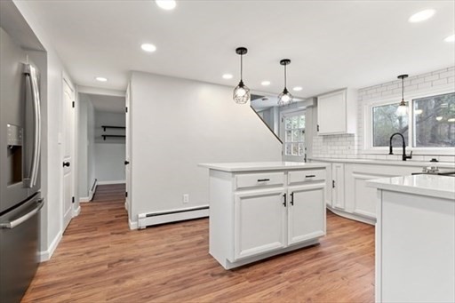 18 Wainwright Avenue Haverhill, MA 01835 - Photo 5 of 10 a large kitchen with a sink and dishwasher stove white cabinets with wooden floor