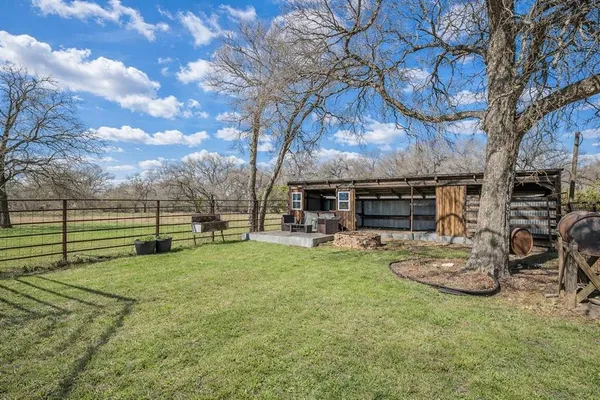 a view of a backyard with table and chairs and a fire pit
