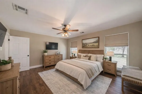 a bedroom with a bed and a flat screen tv