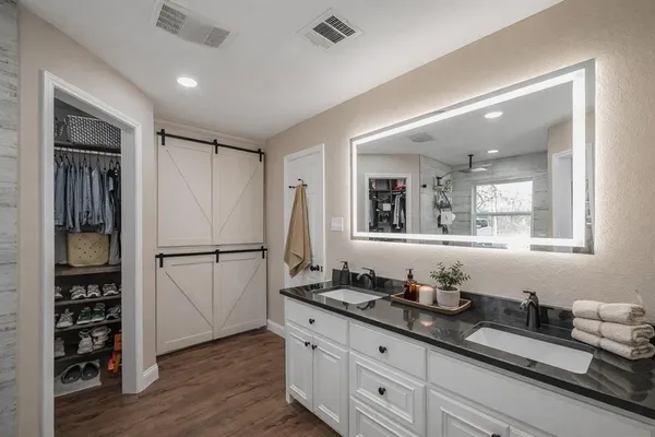 a bathroom with a double vanity sink and a mirror