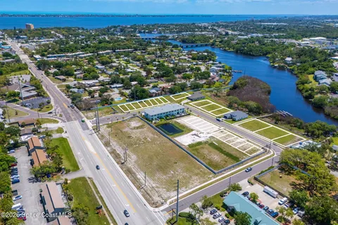 an aerial view of a residential houses with city view