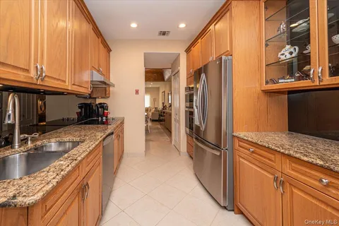 a kitchen with stainless steel appliances granite countertop a refrigerator and a sink