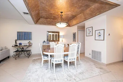 a dining room with furniture a chandelier and window