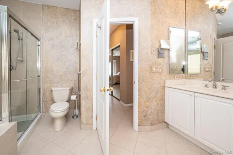 a bathroom with a double vanity sink toilet and shower