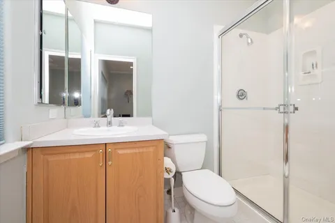 a bathroom with a granite countertop sink toilet and shower