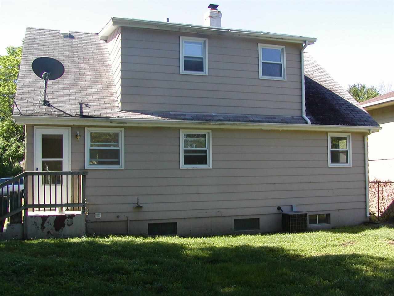 3908 Louisiana Road Rockford, IL 61108 - Photo 7 of 22 a brick house with a yard and plants