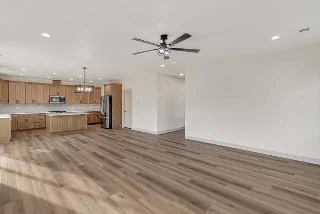 a view of a kitchen with a sink hardwood floor and a kitchen