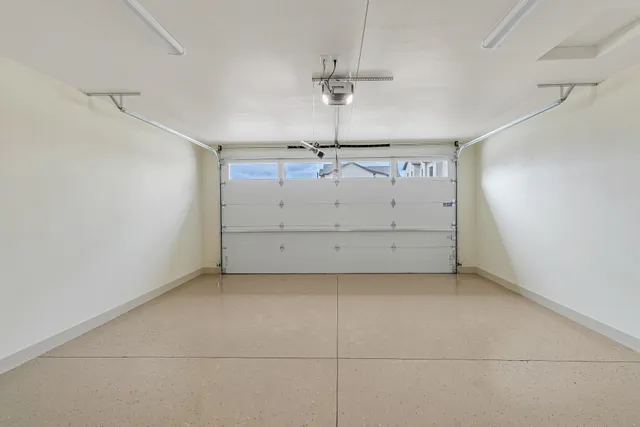 an empty room with chandelier fan