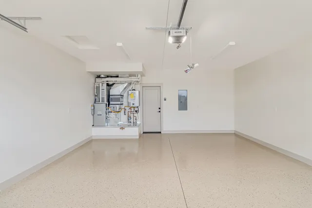 an empty room with ceiling fan and windows