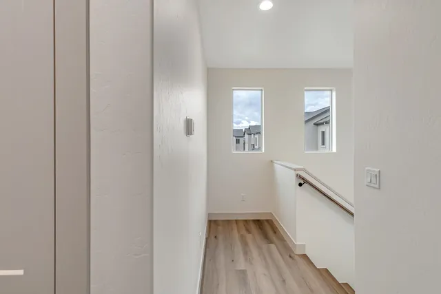 an empty room with a window and a ceiling fan