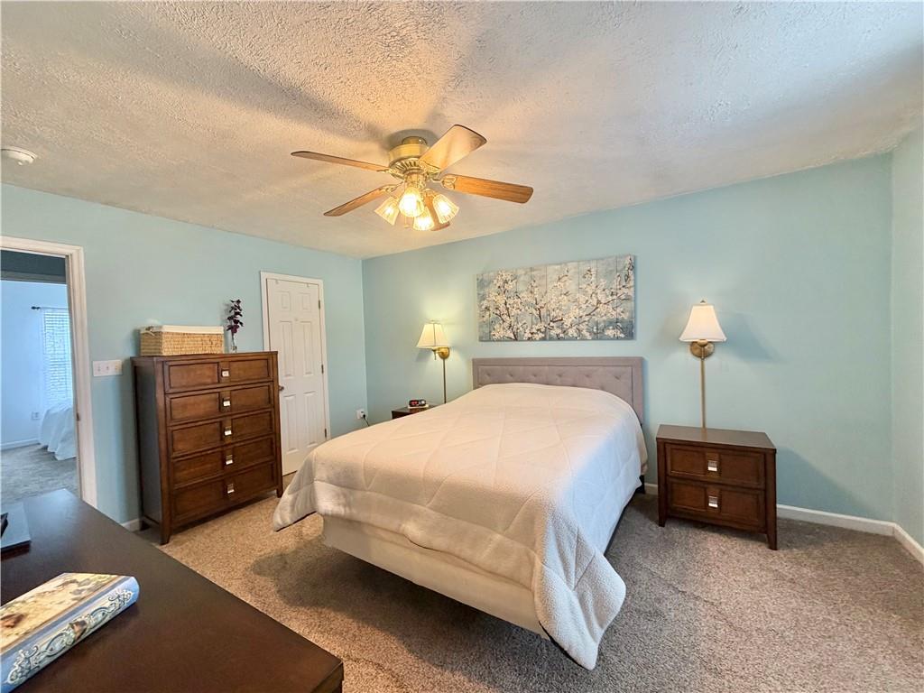 213 Manor View Drive Manor, PA 15665 - Photo 19 of 33 a bedroom with a bed and a chandelier