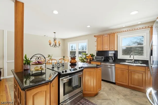a kitchen with granite countertop a sink stove and cabinets