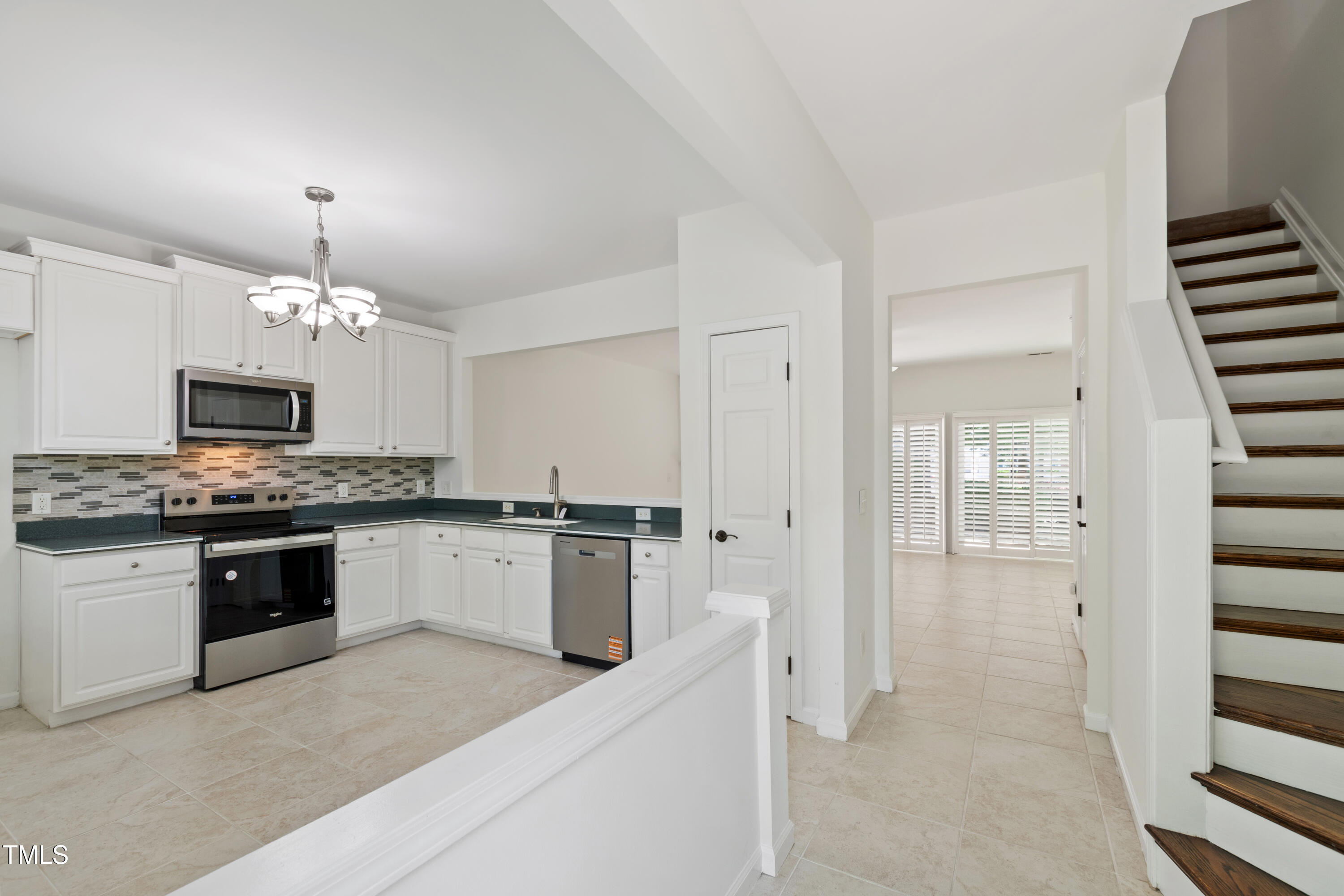 8510 Silhouette Place Raleigh, NC 27613 - Photo 7 of 36 a kitchen with granite countertop white cabinets and white appliances