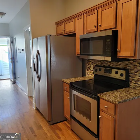 an empty room with a window and a ceiling fan