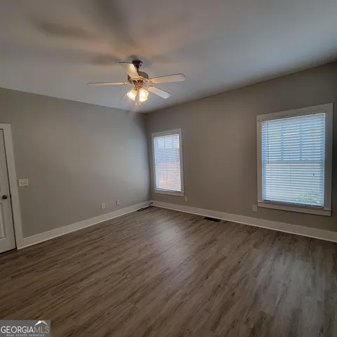 a backyard of a house with barbeque oven and outdoor seating