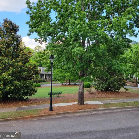 a view of a room with wooden floor and windows