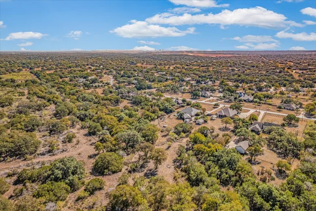 an aerial view of a houses with yard