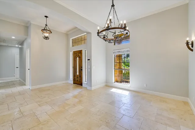 a view of a chandelier fan and refrigerator in a room
