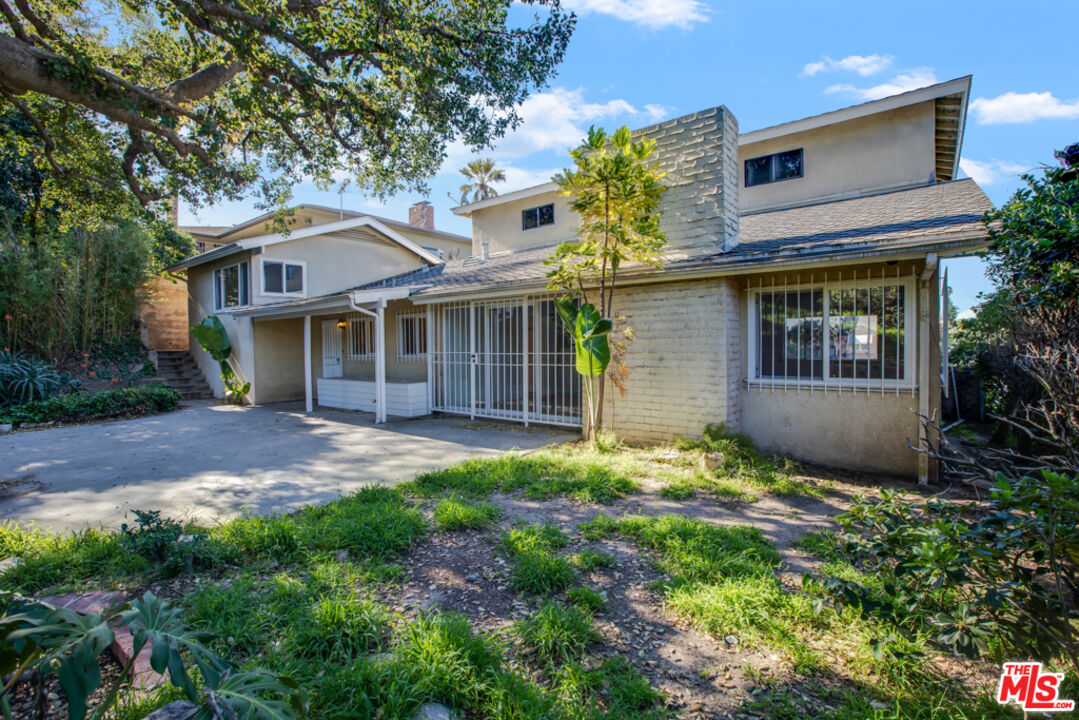 5272 Veronica Street Los Angeles, CA 90008 - Photo 40 of 51 a front view of a house with a garden and outdoor seating