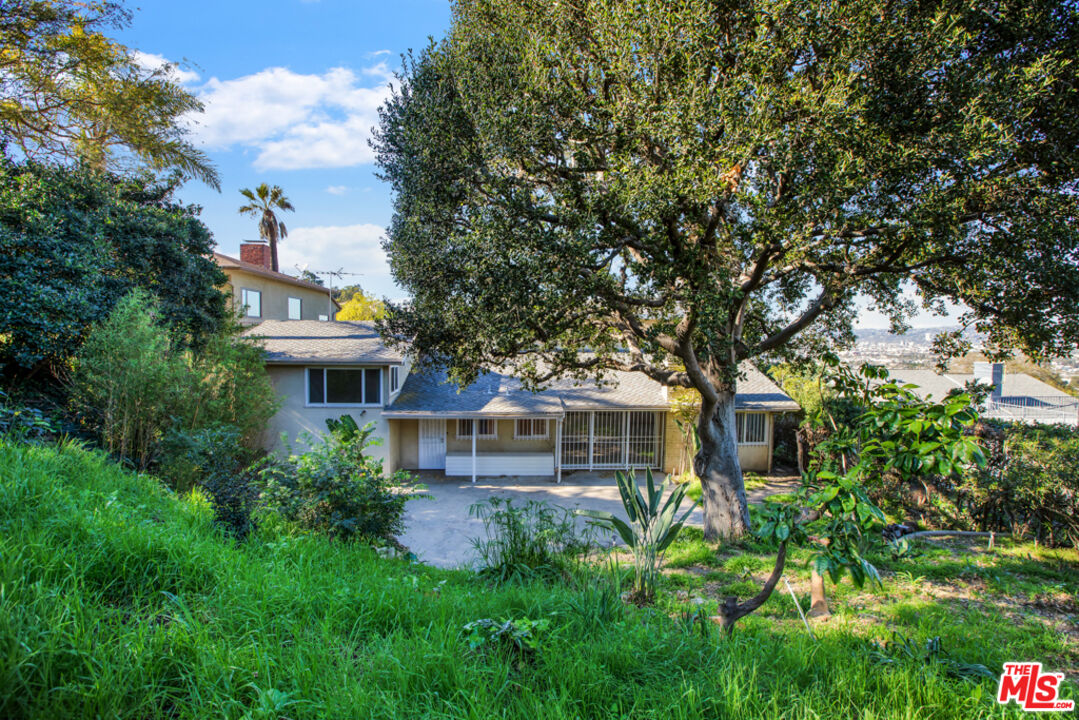 5272 Veronica Street Los Angeles, CA 90008 - Photo 45 of 51 a front view of a house with a yard and potted plants