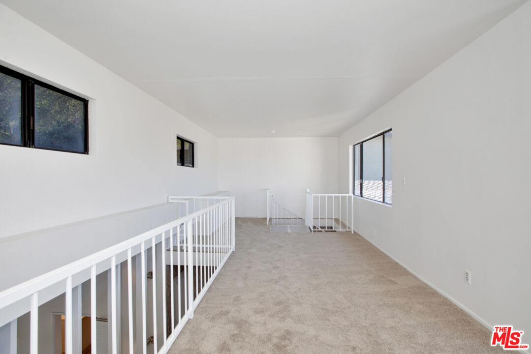 5272 Veronica Street Los Angeles, CA 90008 - Photo 7 of 51 a view of an empty room with wooden floor and a window