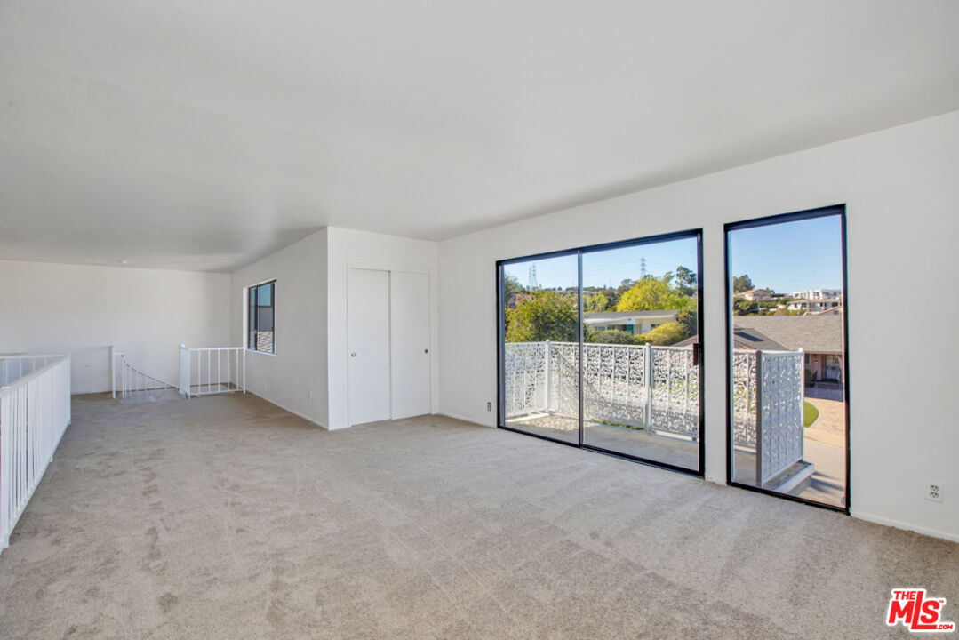 5272 Veronica Street Los Angeles, CA 90008 - Photo 8 of 51 an empty room with sliding glass door and mountain view