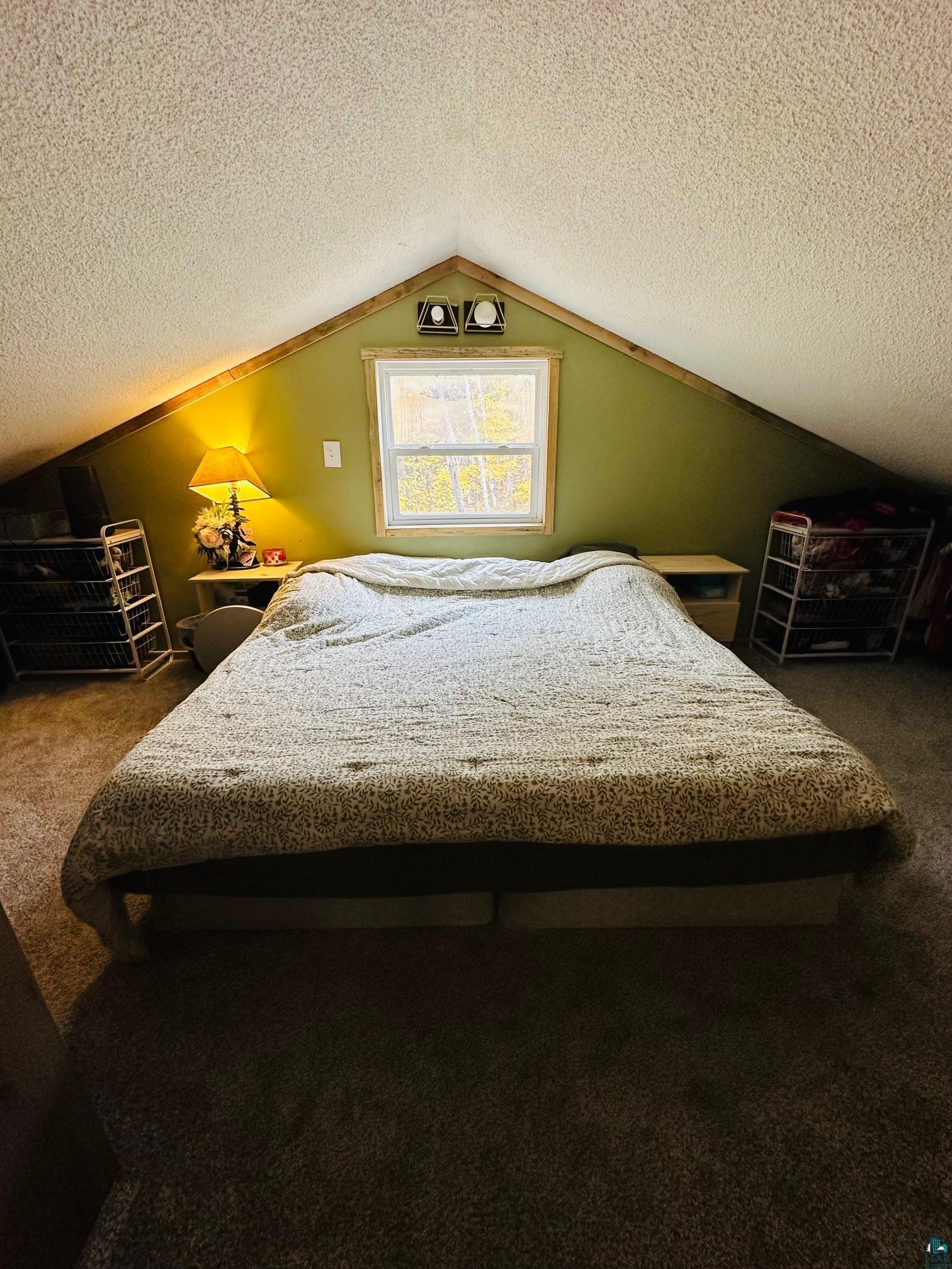 6955 Kolling Road Iron River, WI 54847 - Photo 9 of 22 Bedroom featuring carpet, vaulted ceiling, and a textured ceiling