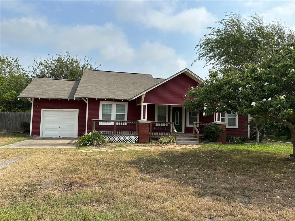 a front view of a house with yard and trees