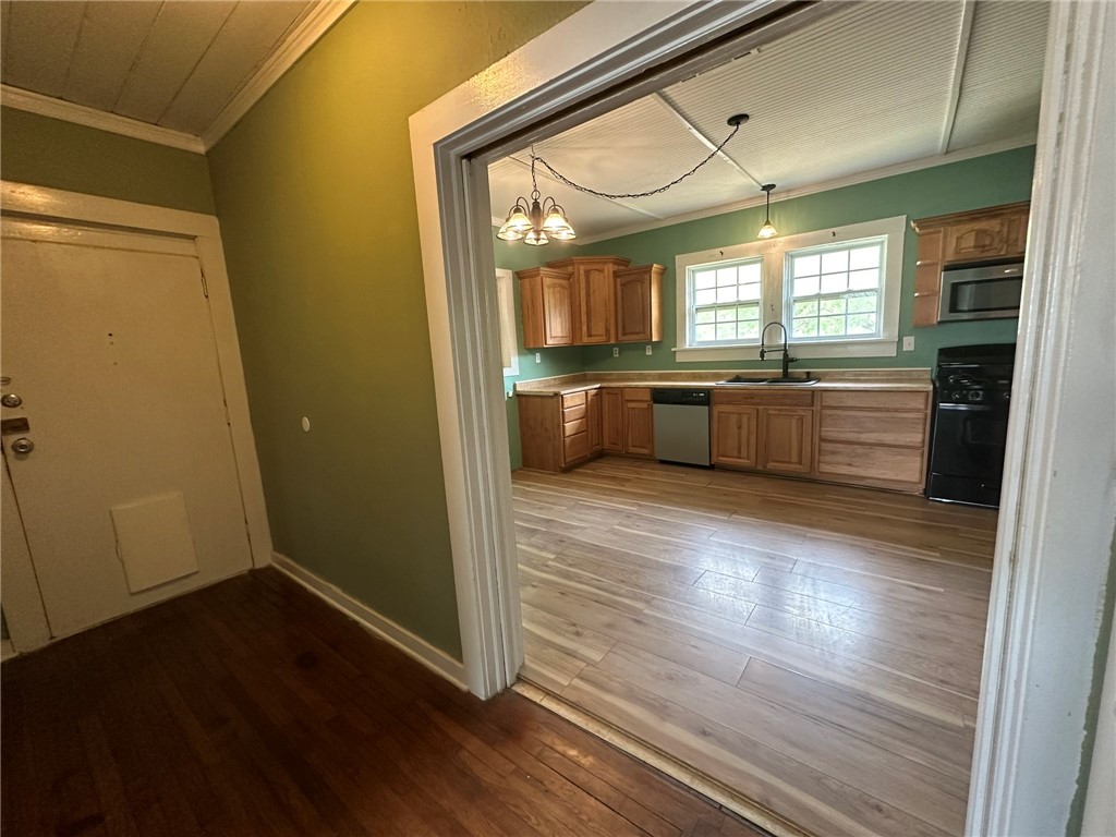 131 Dell Street Portland, TX 78374 - Photo 11 of 40 a large kitchen with a wooden floor and cabinets