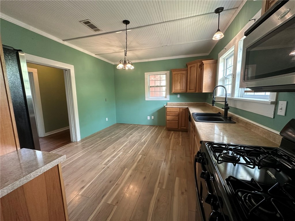131 Dell Street Portland, TX 78374 - Photo 15 of 40 a kitchen with stainless steel appliances granite countertop a stove a sink and a refrigerator