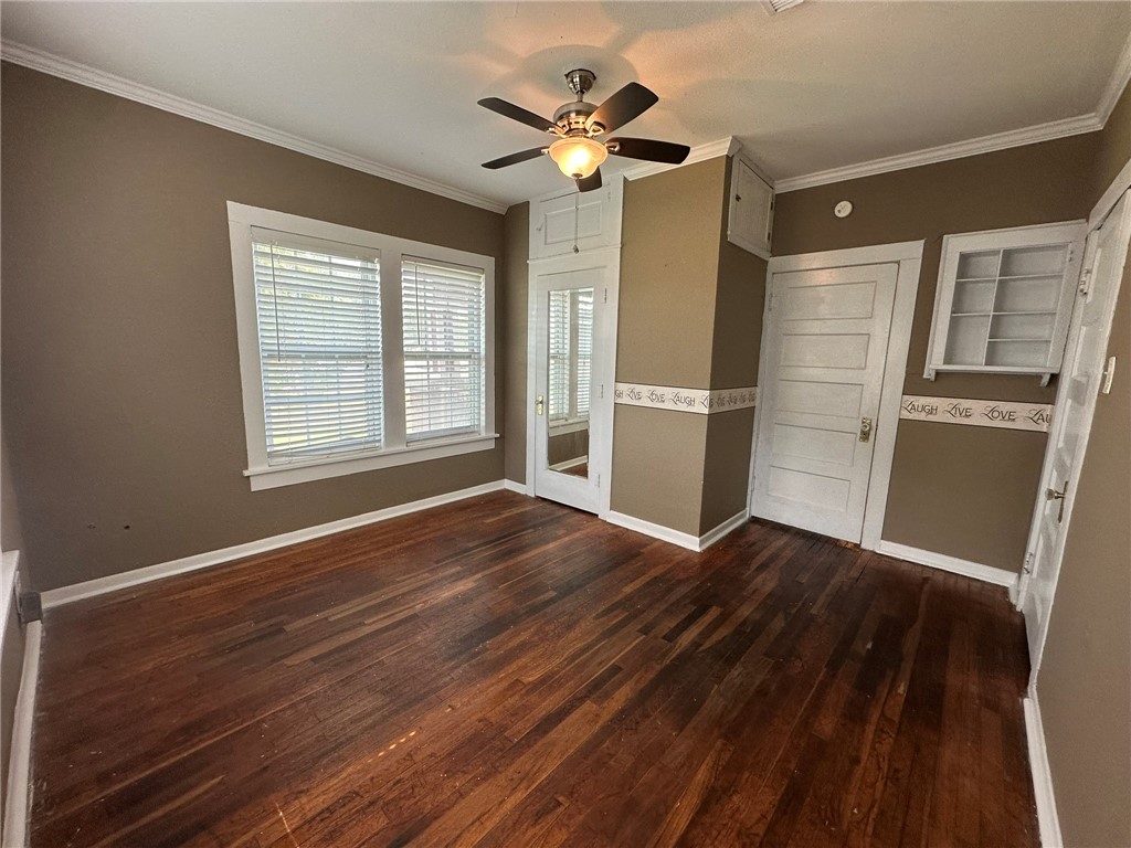 131 Dell Street Portland, TX 78374 - Photo 20 of 40 a view of an empty room with wooden floor and a ceiling fan