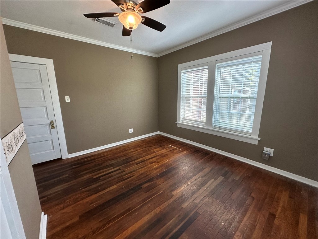 131 Dell Street Portland, TX 78374 - Photo 22 of 40 a view of an empty room with wooden floor and a window