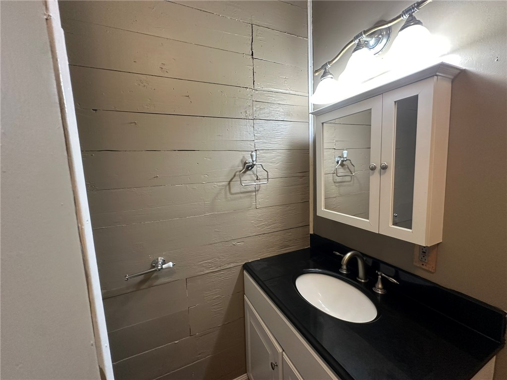 131 Dell Street Portland, TX 78374 - Photo 33 of 40 a bathroom with a granite countertop sink toilet and mirror