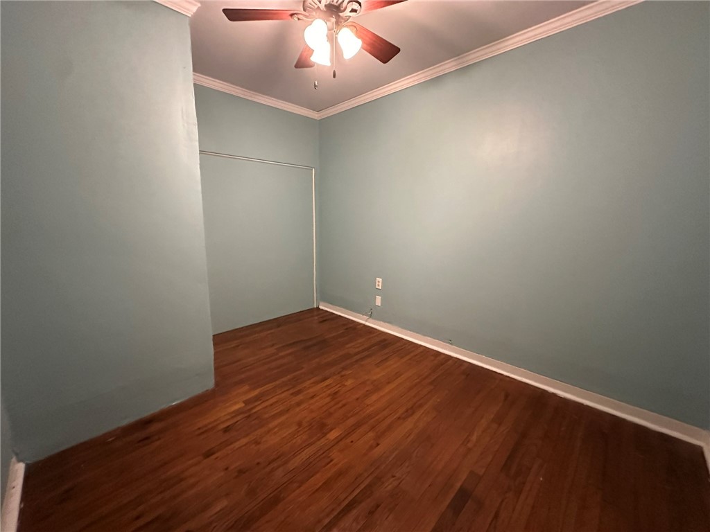 131 Dell Street Portland, TX 78374 - Photo 38 of 40 an empty room with wooden floor and fan