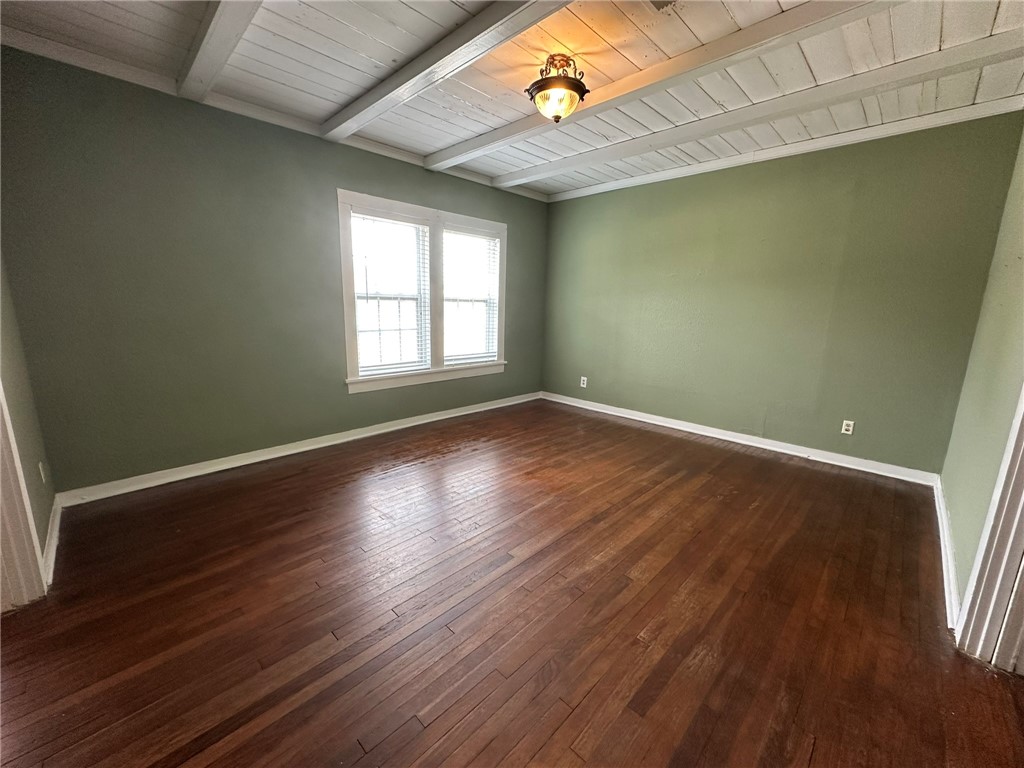 131 Dell Street Portland, TX 78374 - Photo 8 of 40 an empty room with wooden floor and windows
