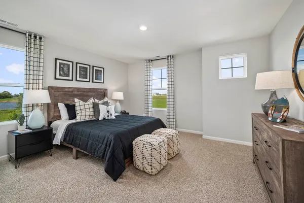 a bedroom with bed and window