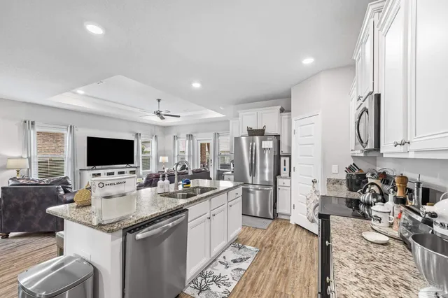 a kitchen with granite countertop lots of counter top space and living room