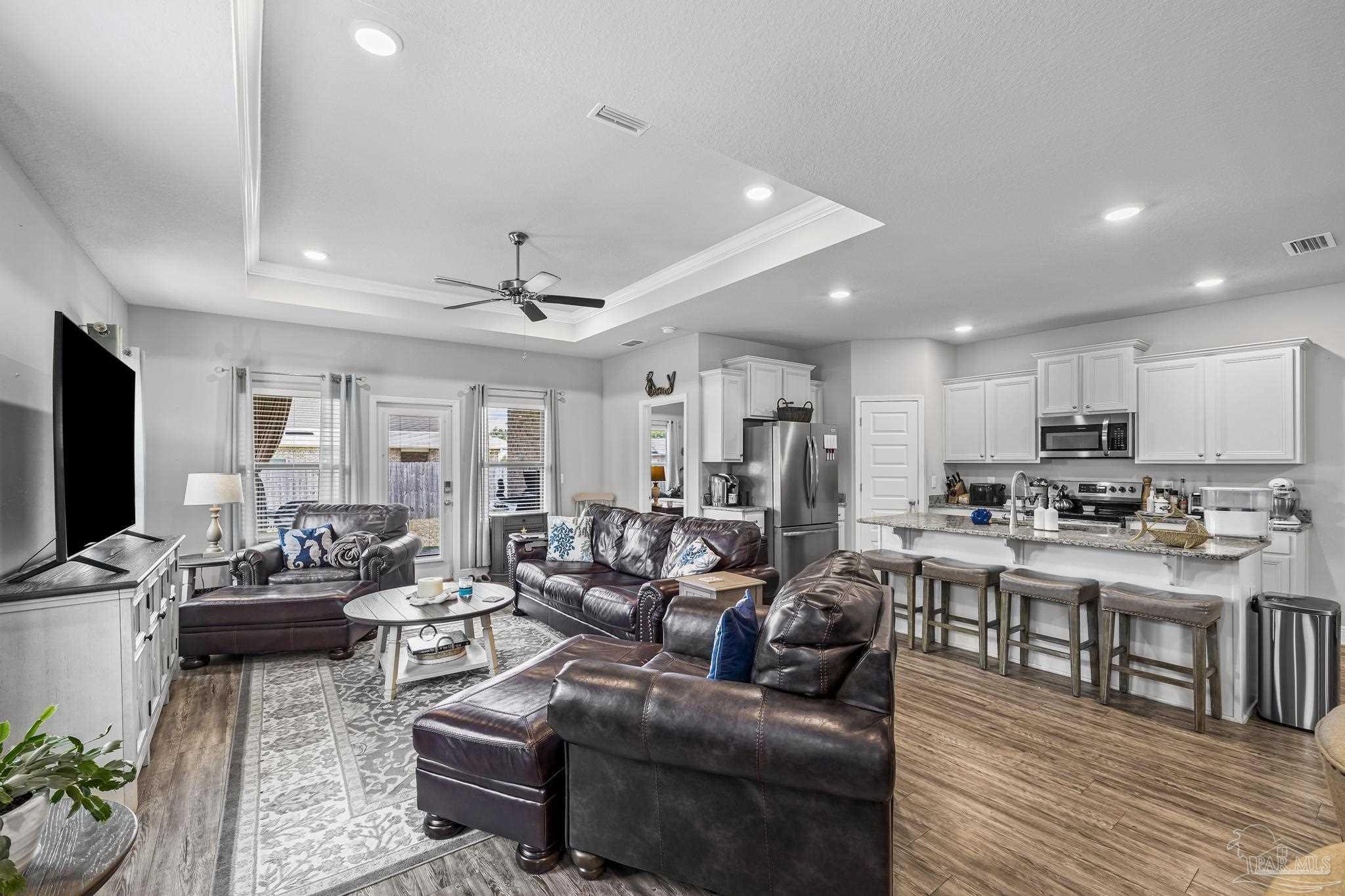 5375 Red Shoulder Road Pace, FL 32571 - Photo 19 of 40 a living room with lots of furniture and a wooden floor