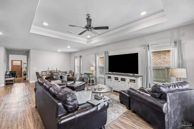 a living room with lots of furniture and a wooden floor