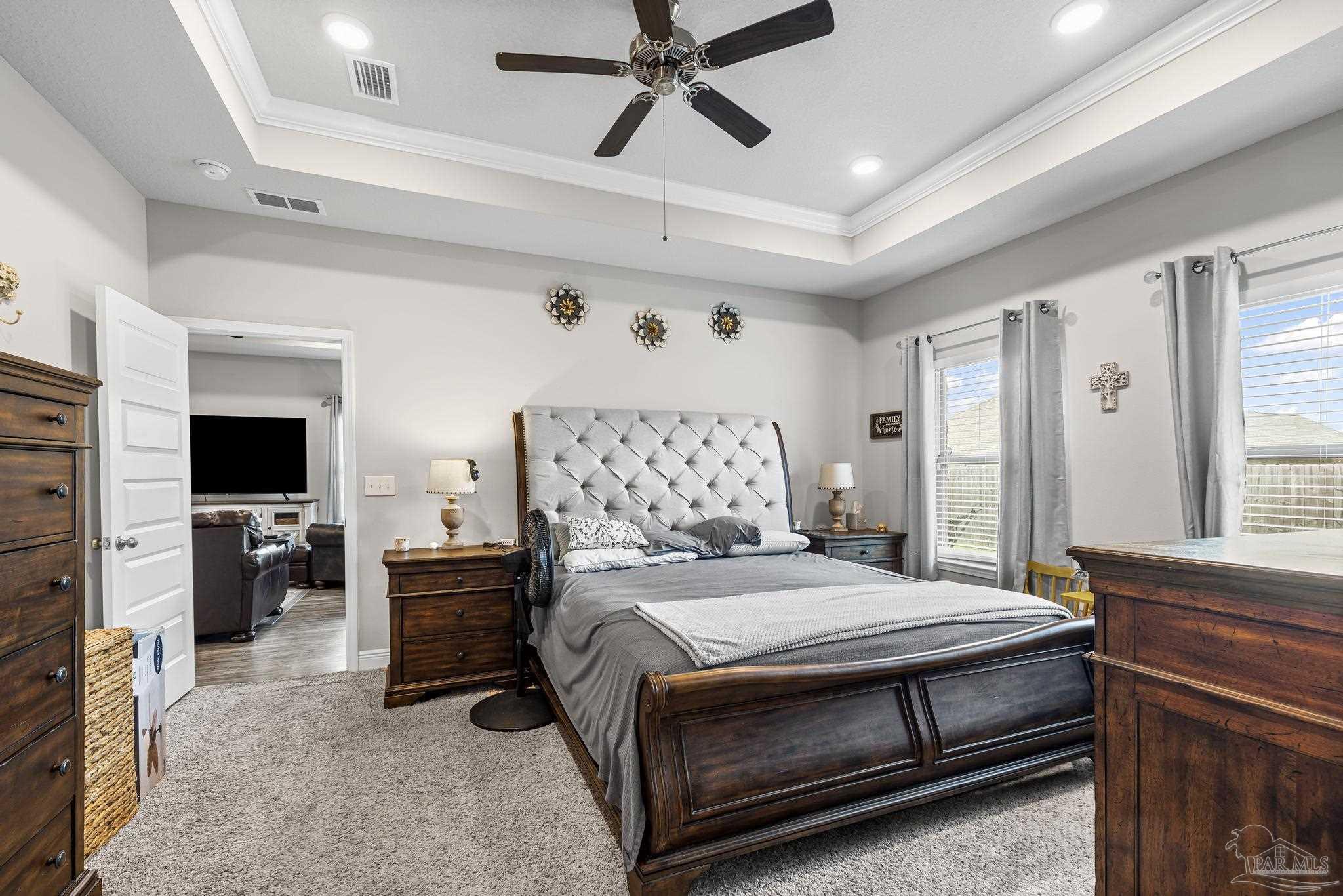 5375 Red Shoulder Road Pace, FL 32571 - Photo 24 of 40 a bedroom with a bed and a flat screen tv