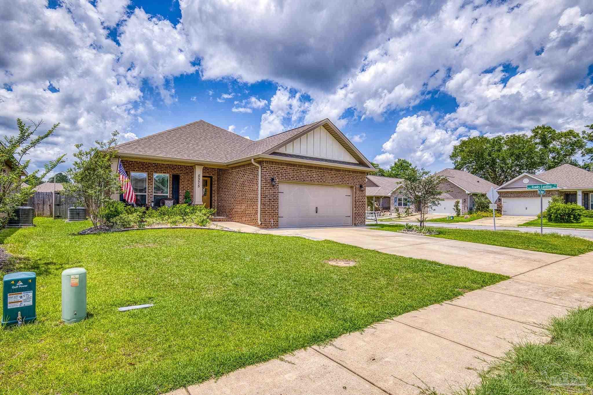 5375 Red Shoulder Road Pace, FL 32571 - Photo 25 of 40 a front view of a house with garden