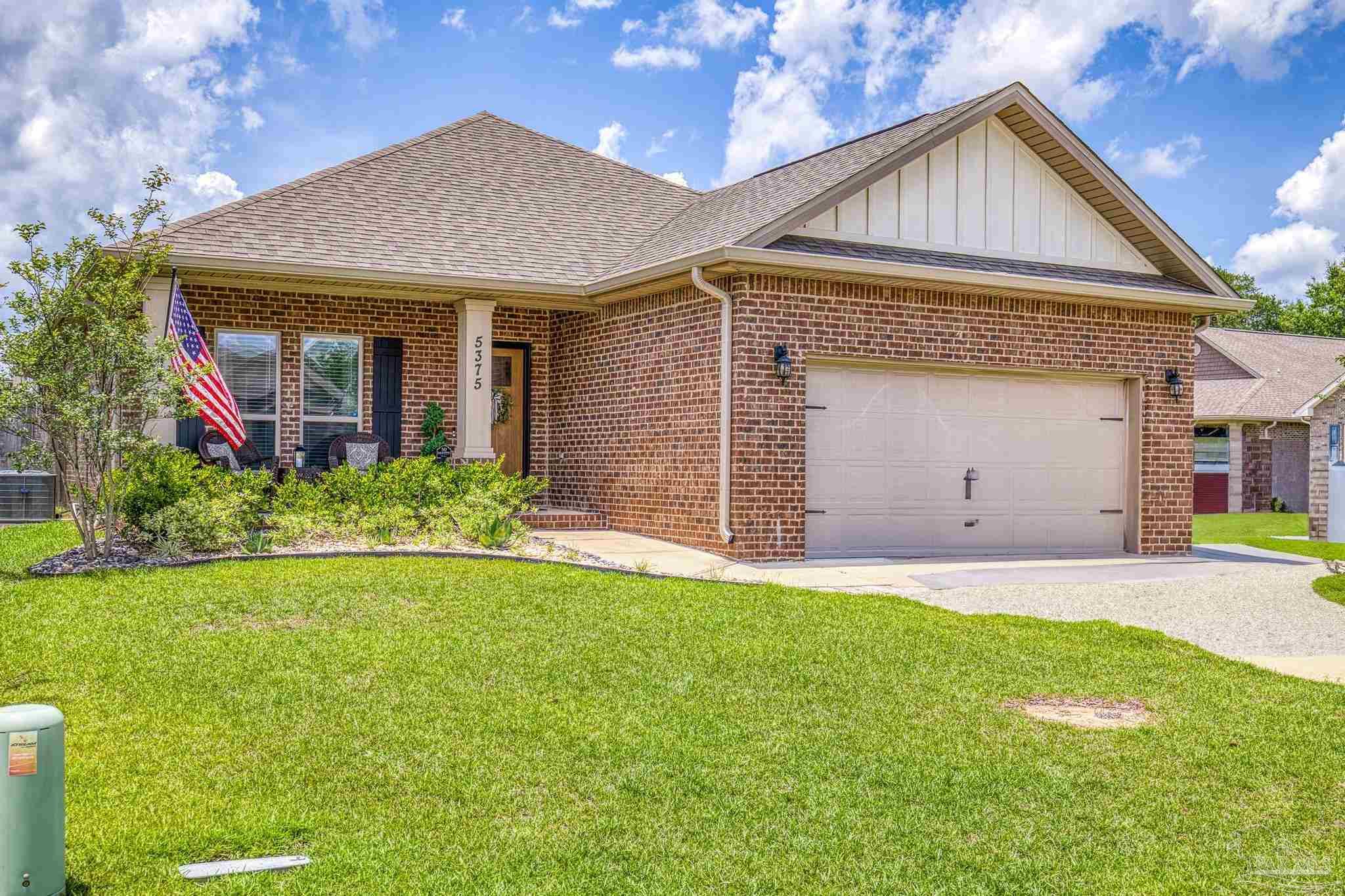 5375 Red Shoulder Road Pace, FL 32571 - Photo 26 of 40 a front view of a house with a yard and garage