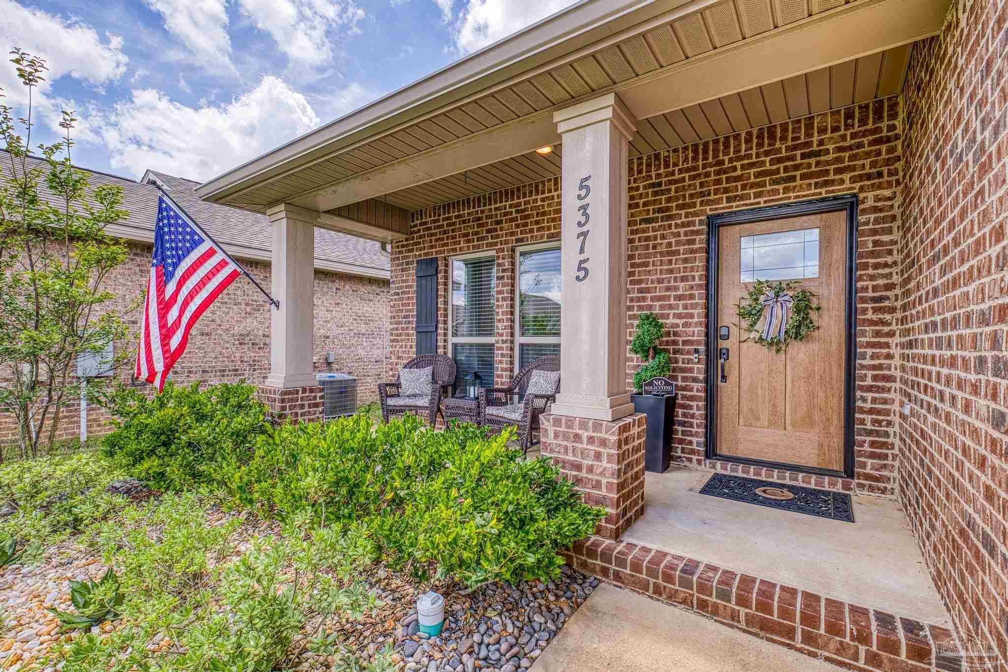 5375 Red Shoulder Road Pace, FL 32571 - Photo 29 of 40 a front view of a house with a garden