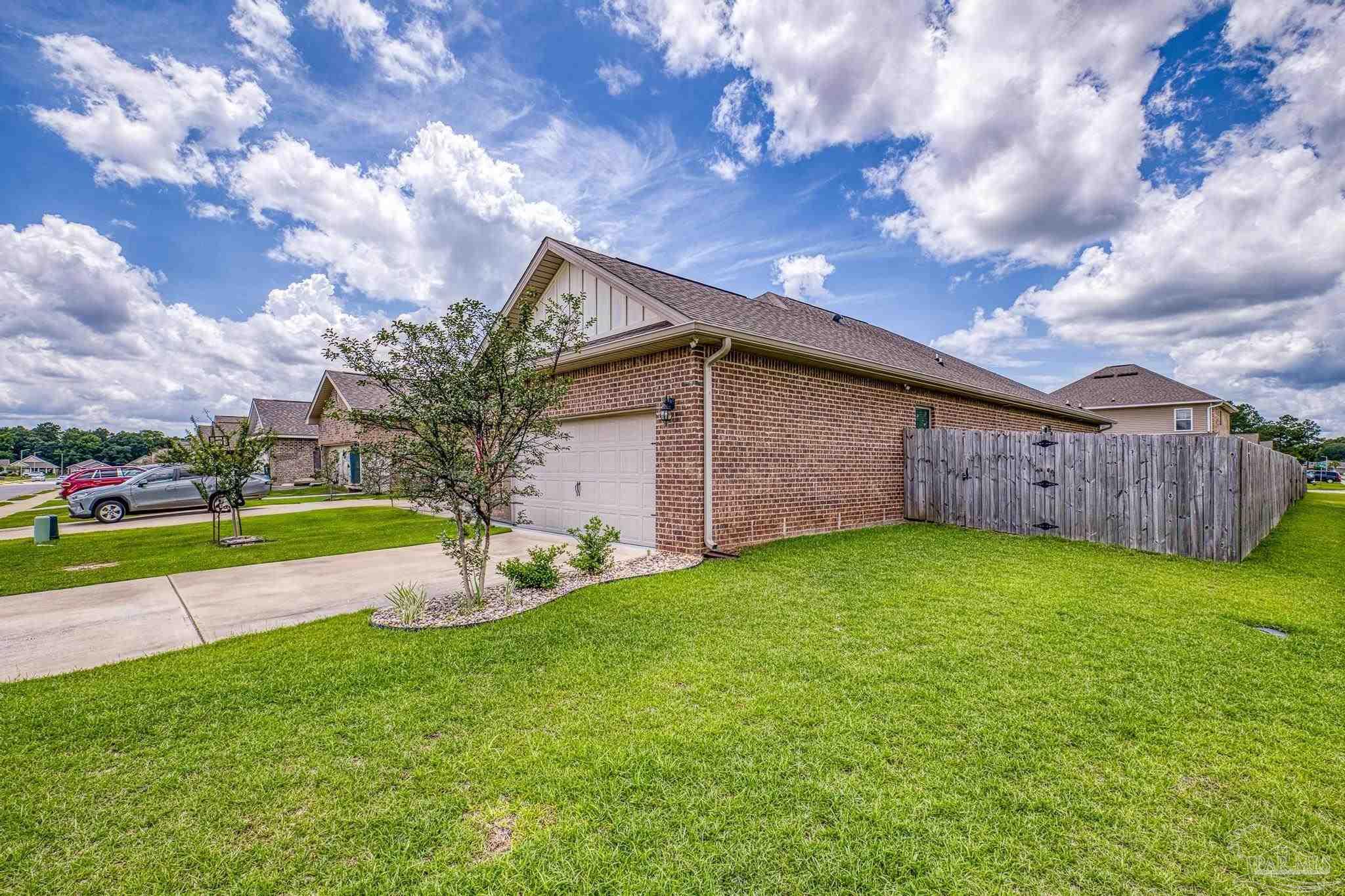 5375 Red Shoulder Road Pace, FL 32571 - Photo 31 of 40 a view of an house with backyard space and garden view